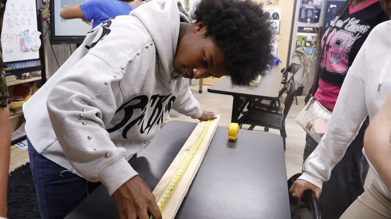 Electrical student demonstrating precise measurement