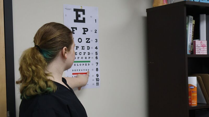 Health Science student conducting an eye exam