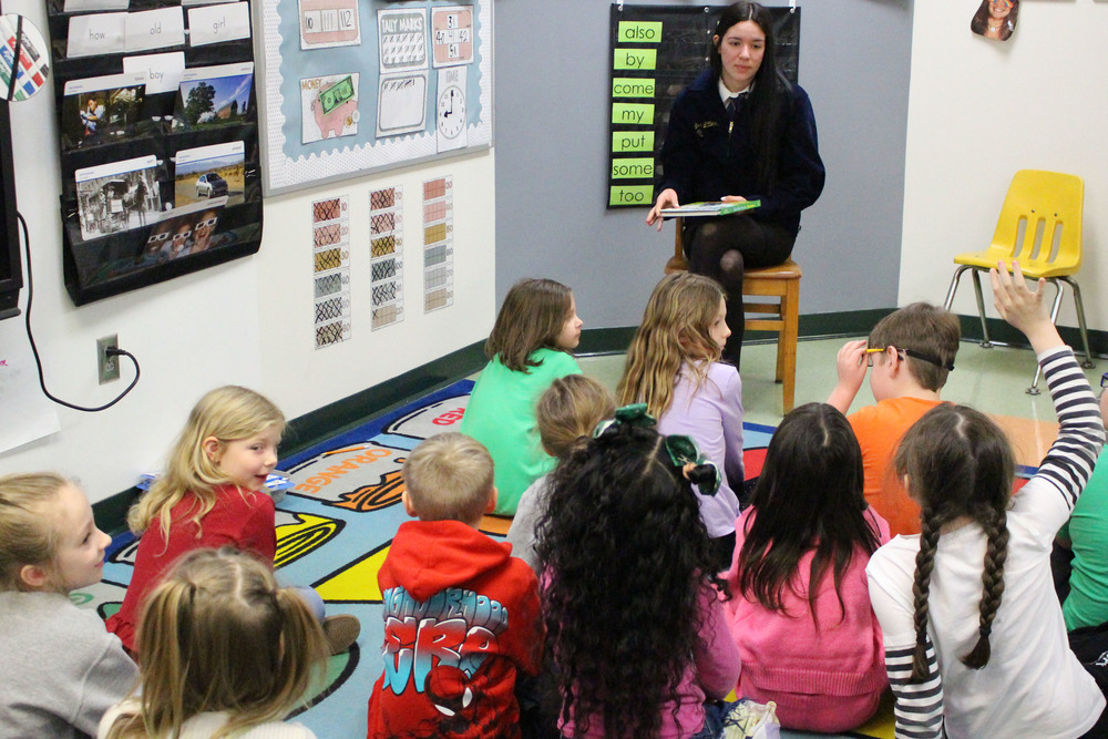 JMHS FFA members reading to McNinch Primary students