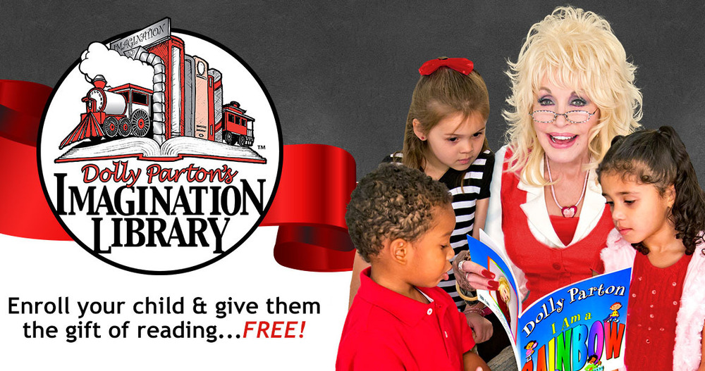 Dolly Parton in red dress and glasses holding books, standing with two children in front of "Dolly Parton's Imagination Library" sign.