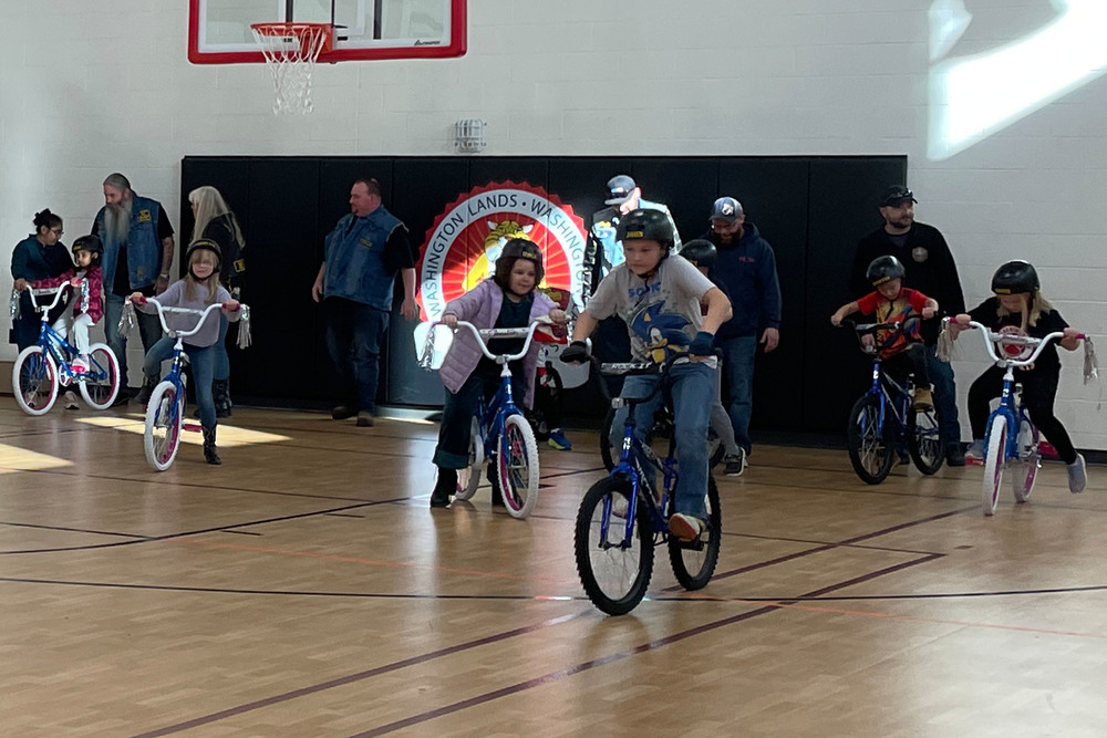 Kids and Warlords Motorcycle Club members with the new bikes.