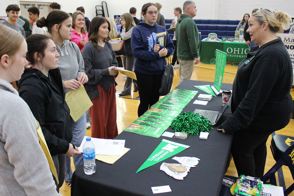 Students talk to a university representative.