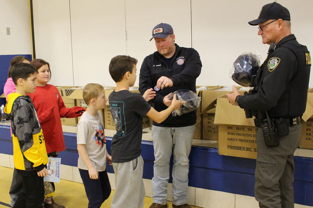 Cameron Elementary students get their new bike helmets.