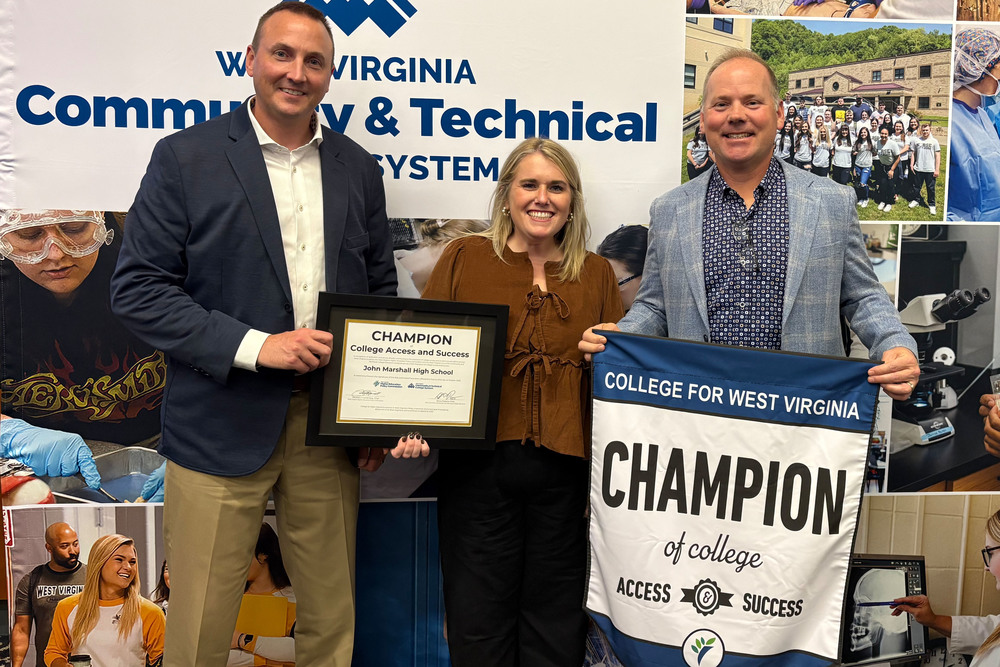 Receiving the Champions for College Access and Success award, from left, are Marshall County Schools Student Services Director Casey Storm, John Marshall High School Counselor Chelsea Eikleberry and John Marshall High School Principal Jason Marling. 