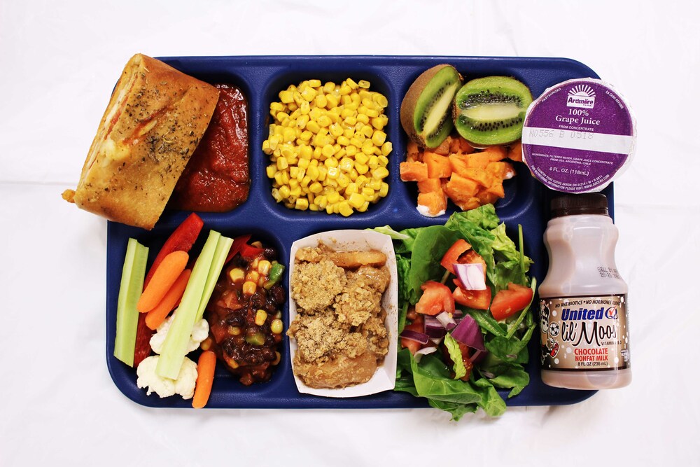 Tray of food on a blue school lunch tray.