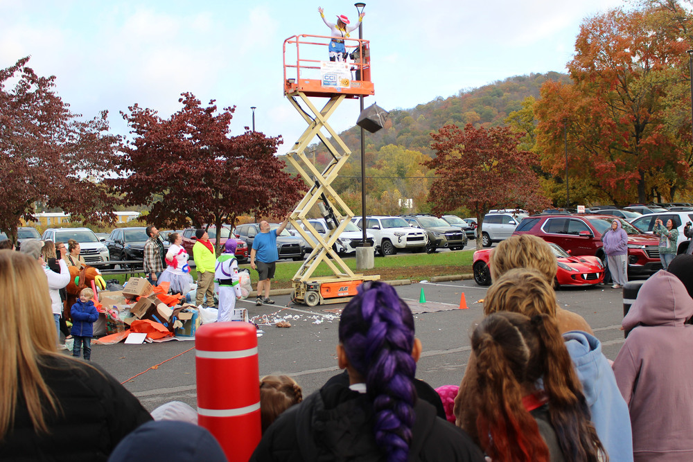 WLES Principal Julie Sturgill tosses the next pumpkin from the lift.