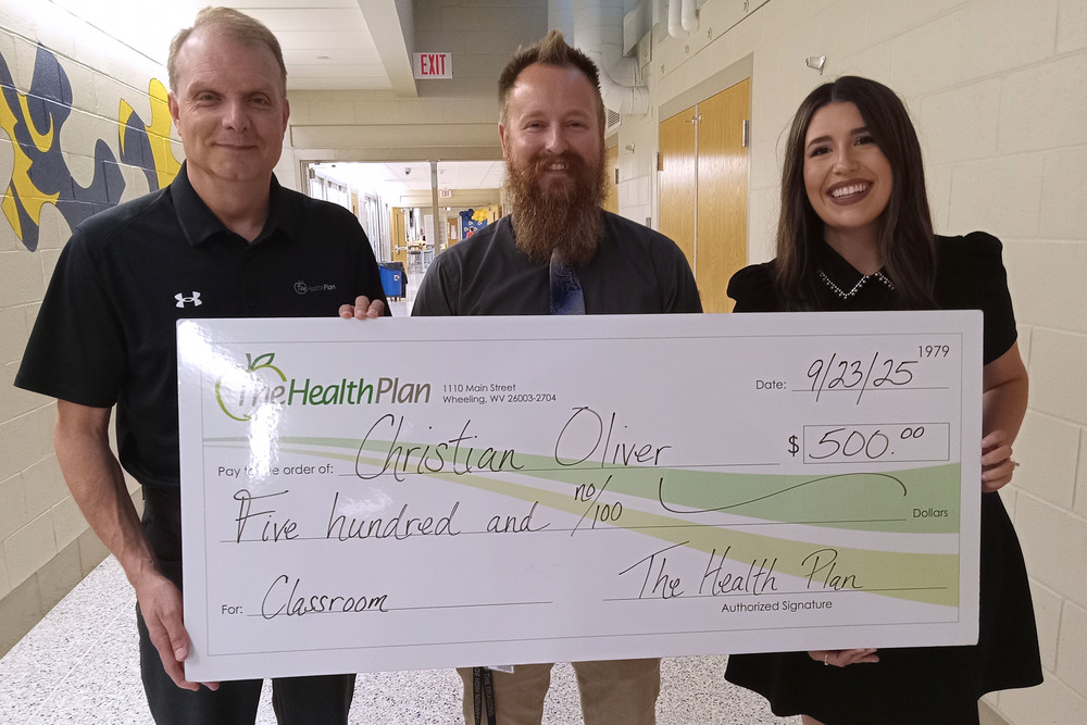 Pictured from left: David Flatley, Christian Oliver and Annalise Murphy are holding an oversized check.