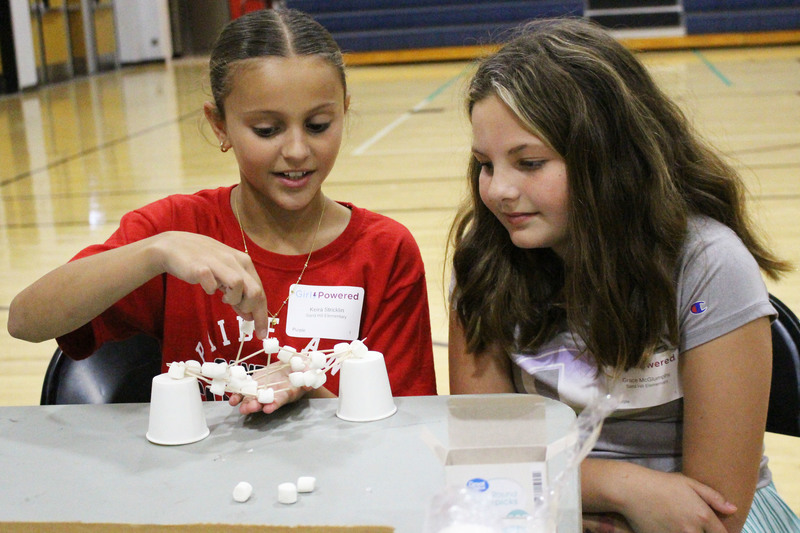 Pictured from left: Sand Hill Elementary students Keira Stricklin and Grace McGlumphy try to build a sturdy bridge using paper cups, toothpicks and marshmallows. 