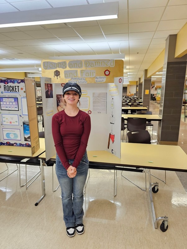 Student in front of their project