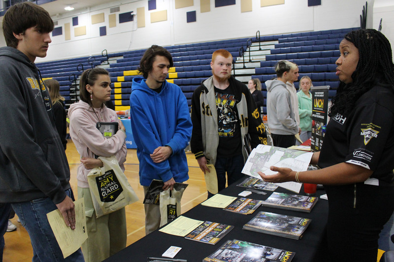 Students talk to a trade school representative.
