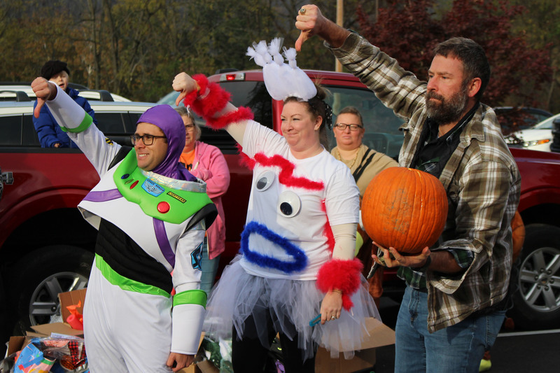 From left: WLES Music teacher Eli Lambie, Gifted and Enrichment teacher Lauren Yurko and Physical Education teacher Michael Grimm give the thumbs-down to the students whose pumpkin cracked after falling 25 feet.