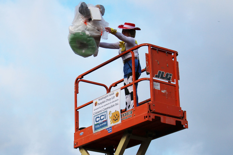WLES Principal Julie Sturgill tosses the next pumpkin from the lift.