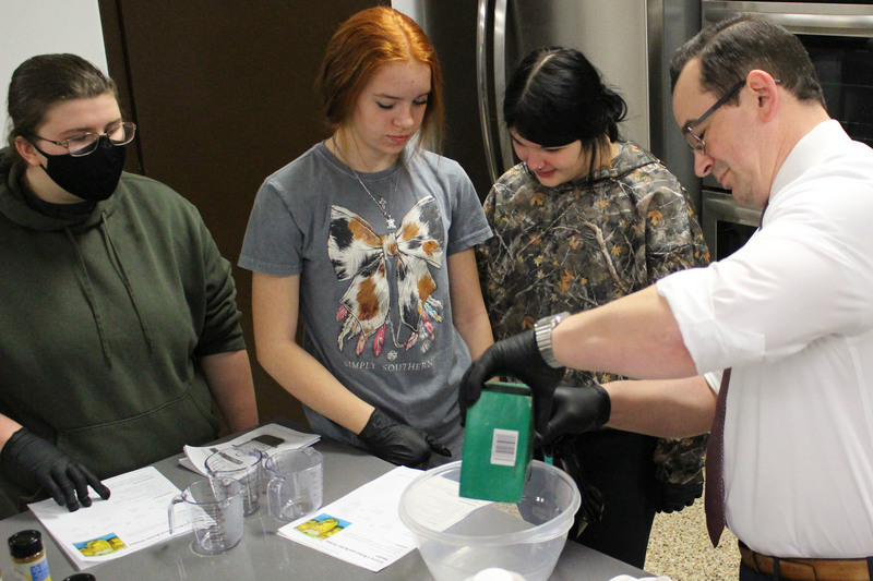 Students learning how to make make homemade bread and butter-style pickles and can them.