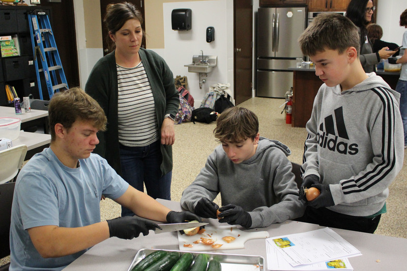 Students learning how to make make homemade bread and butter-style pickles and can them.