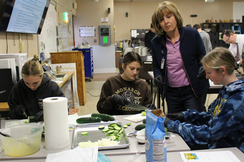 Students learning how to make make homemade bread and butter-style pickles and can them.