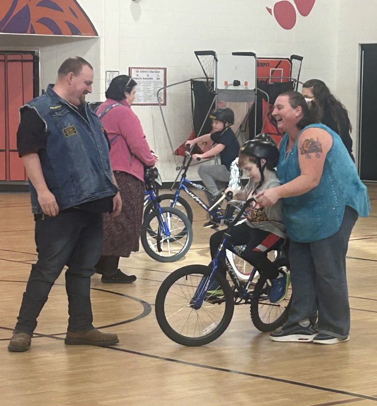 Kids and Warlords Motorcycle Club members with the new bikes.
