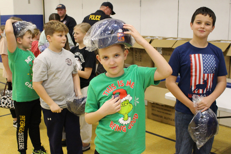 Cameron Elementary students get their new bike helmets.