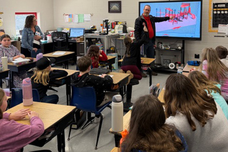 Students look at different design and equipment options for the school’s new playground project.