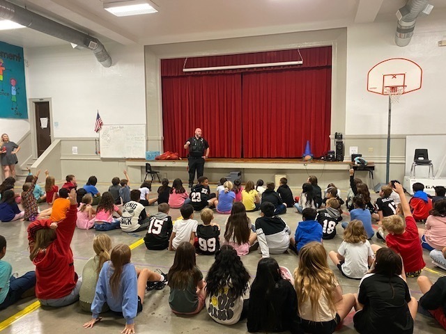 Officer speaking to group of students