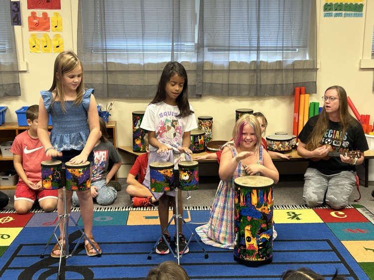 girl students playing drums
