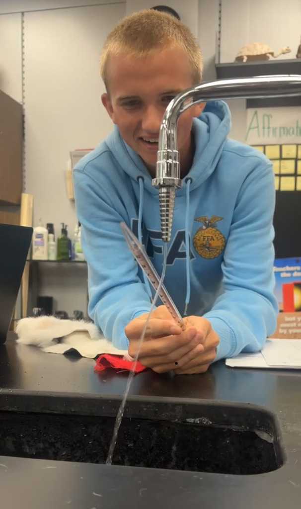 Student bending water with polarity.