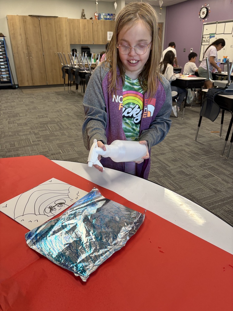 little girl doing art with spray bottle