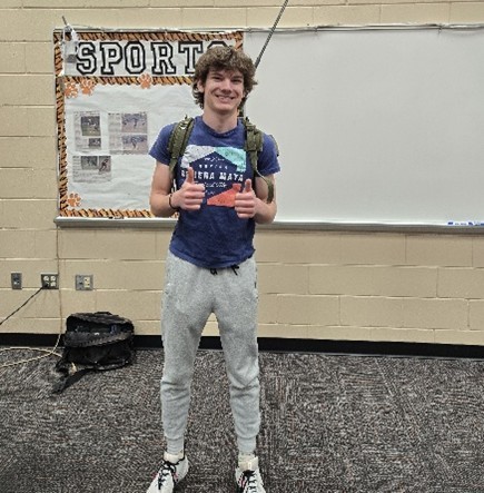 young man wearing military backpack