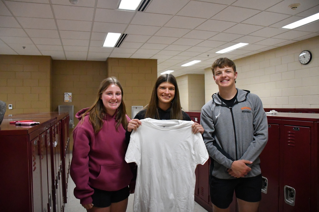3 kids one holding a white shirt