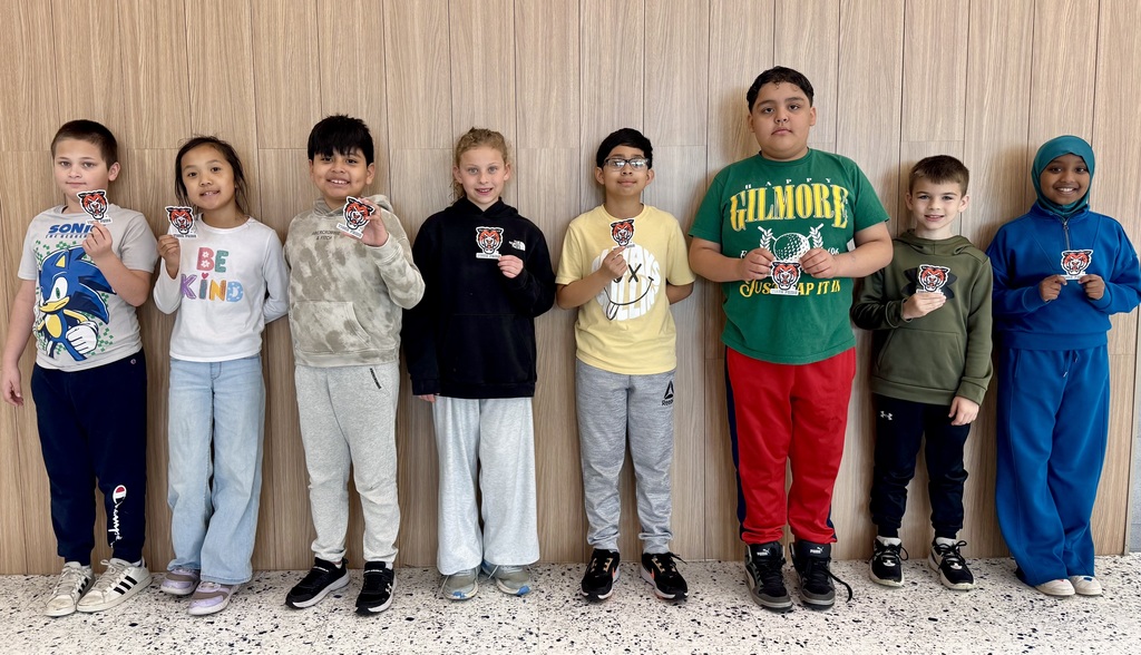 Group of kids holding up tiger logos