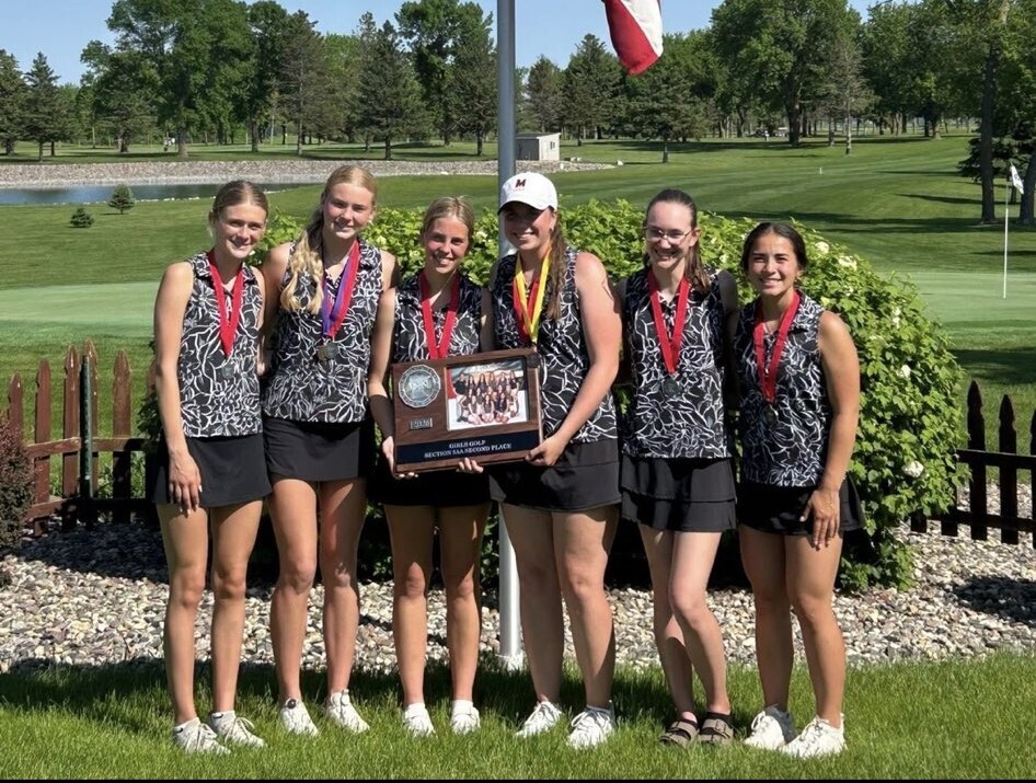 Group of girls holding a plaque