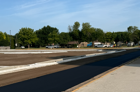 Construction crew laying asphalt
