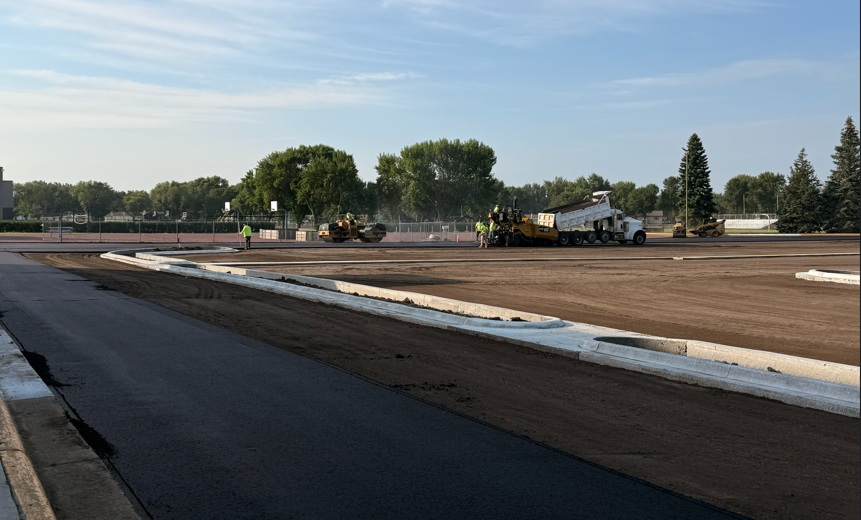 Construction crew laying asphalt