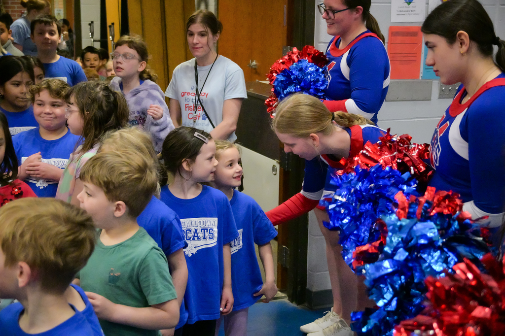Young student talking to cheerleader