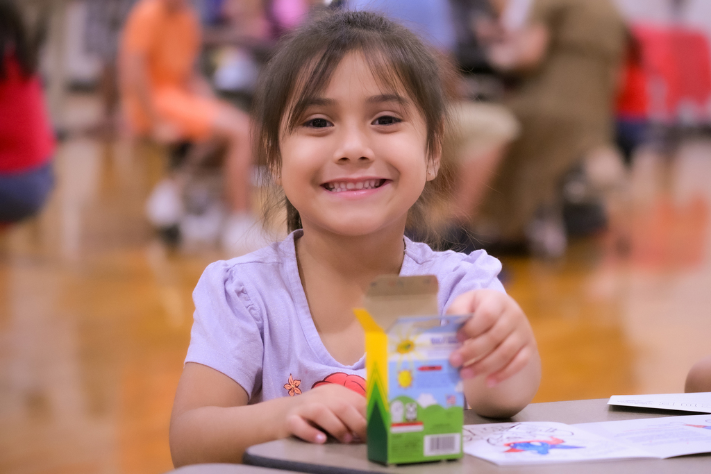 Student coloring a coloring book
