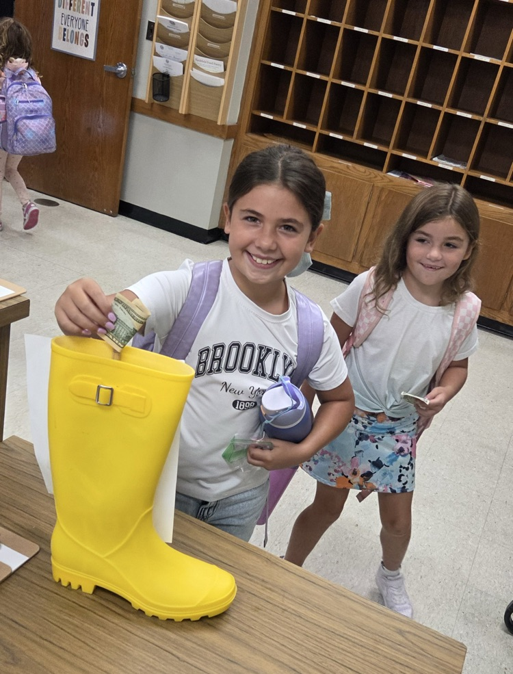 students putting money in the gold boot