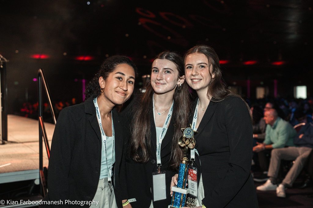 Three students with trophy