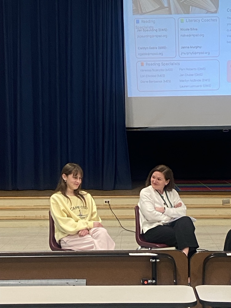 student and presenter on stage 