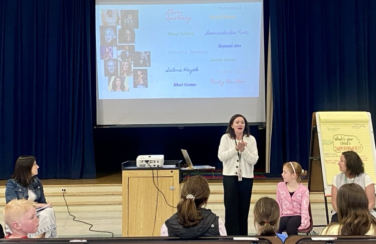 student and presenter on stage 