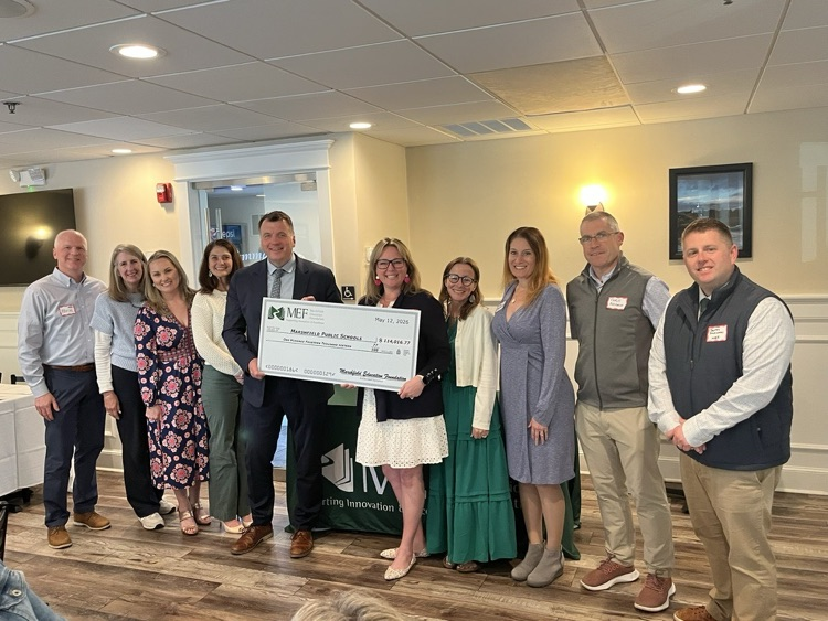 board members of MEF presenting check to MPSD