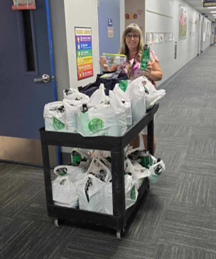 Becky B handing our water bottles