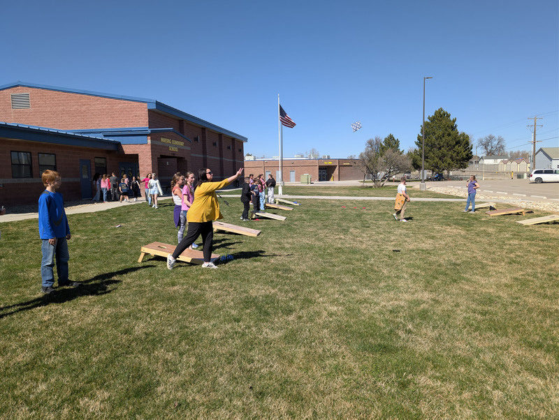 Teacher playing corn hole