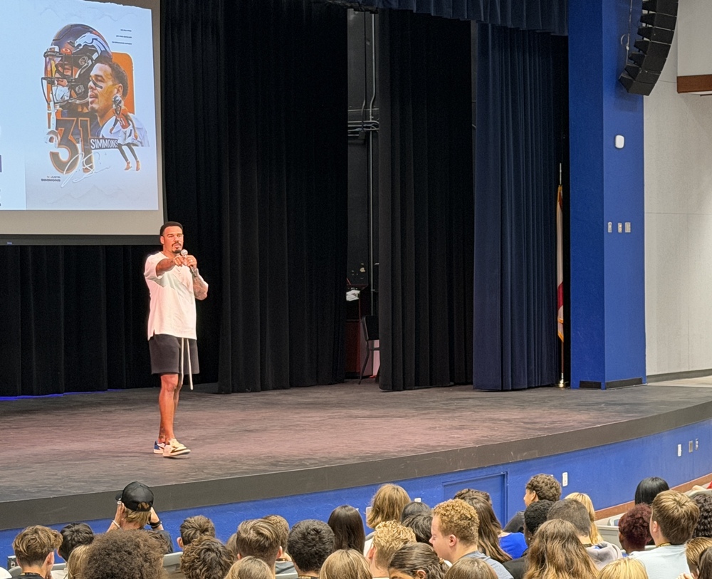 Justin Simmons speaks to MCHS students in the school's auditorium