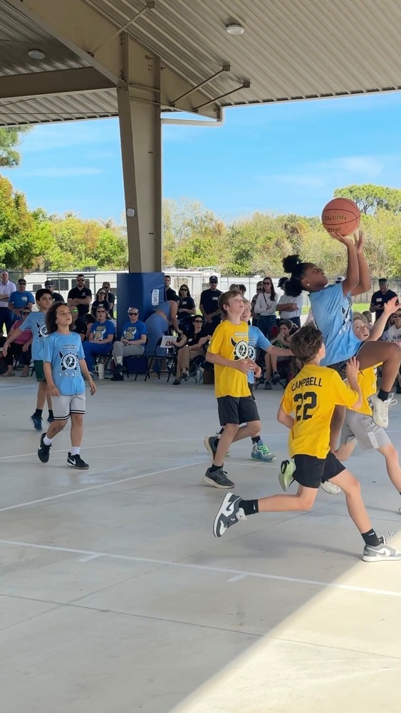 Jensen Beach Elementary School's Basketball Club player goes in for a layup and makes it.