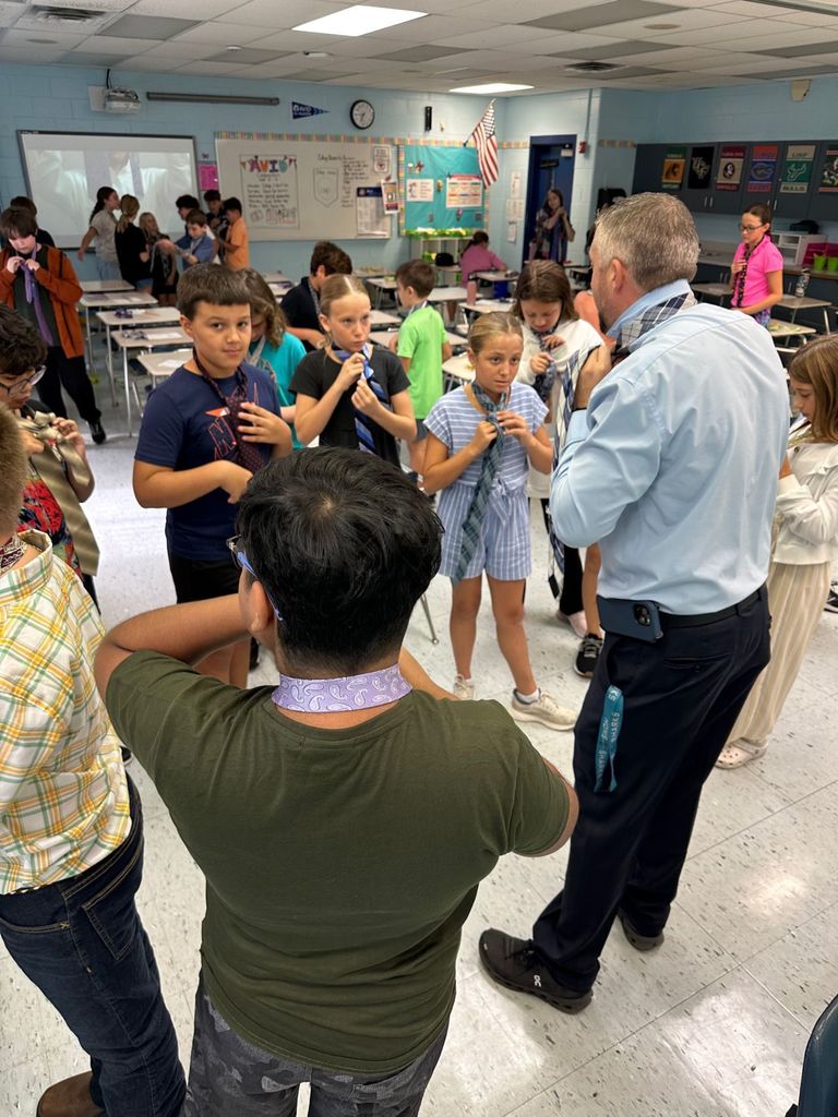 HOMS Principal teaches students how to tie a tie for AVID
