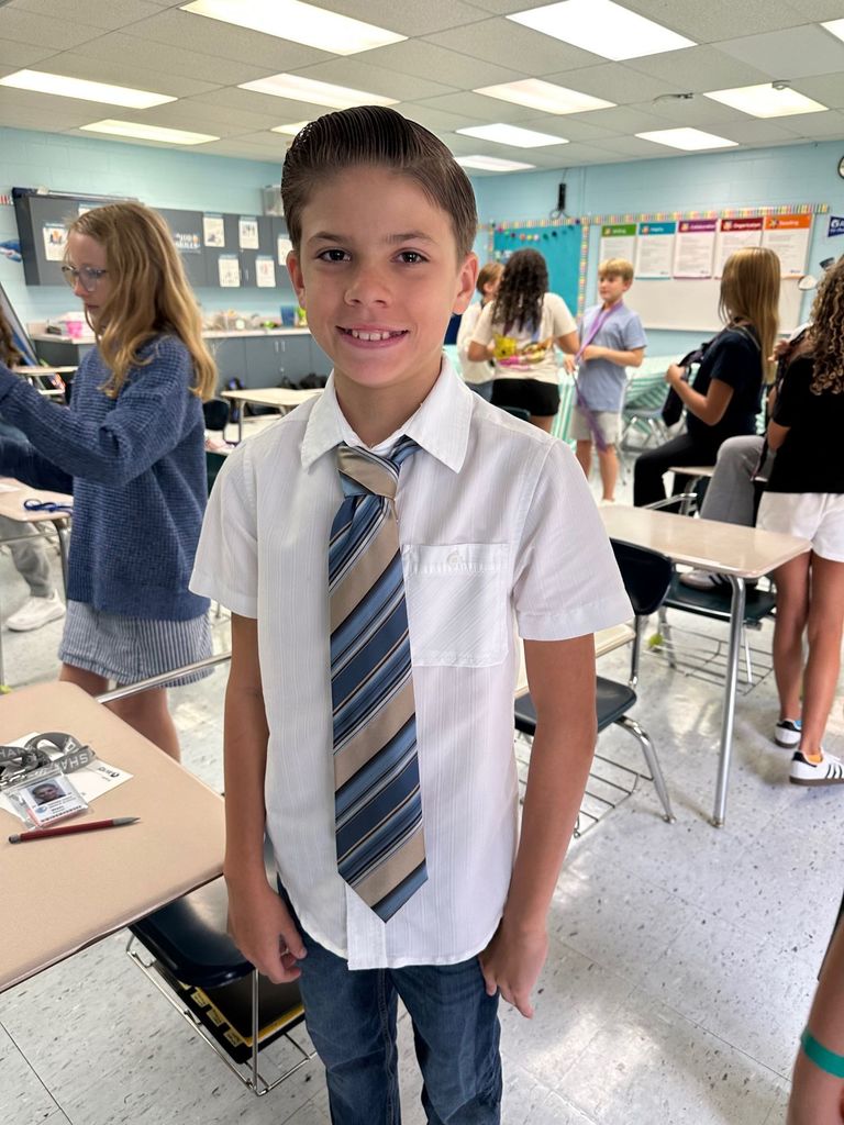 HOMS Principal teaches students how to tie a tie for AVID