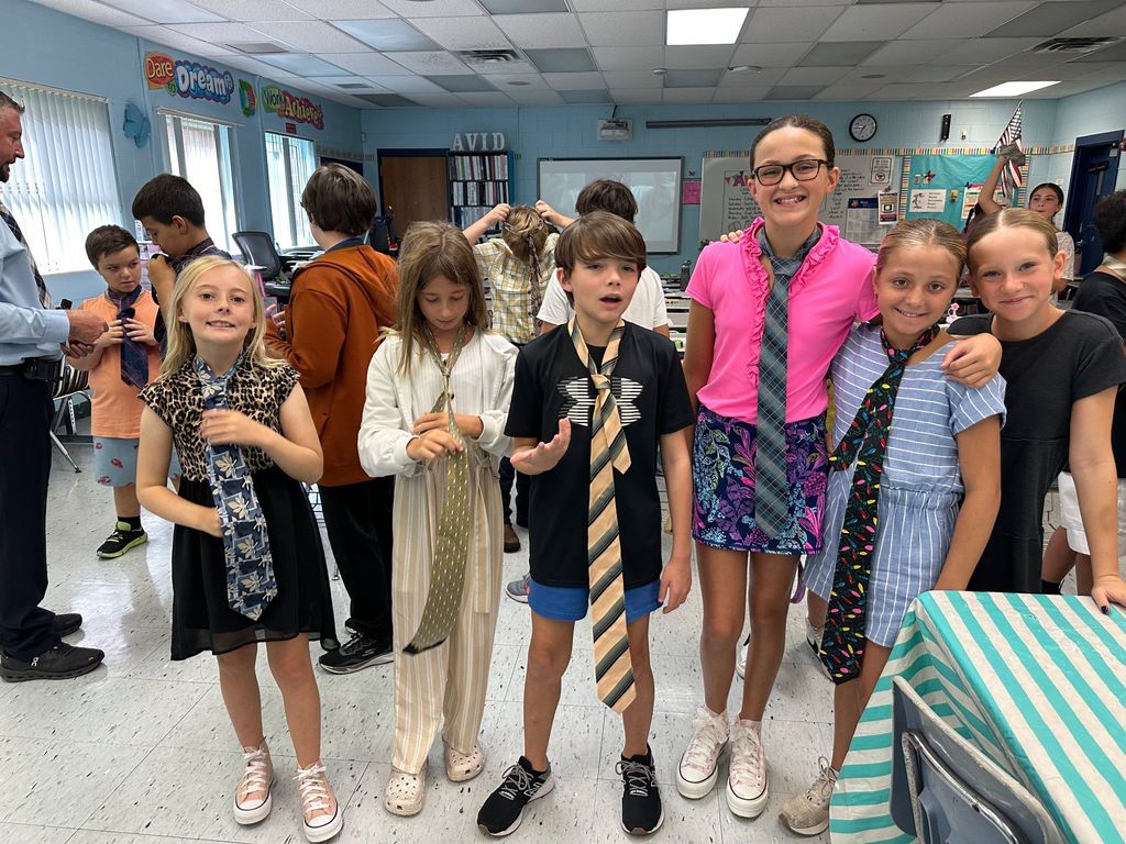 HOMS Principal teaches students how to tie a tie for AVID