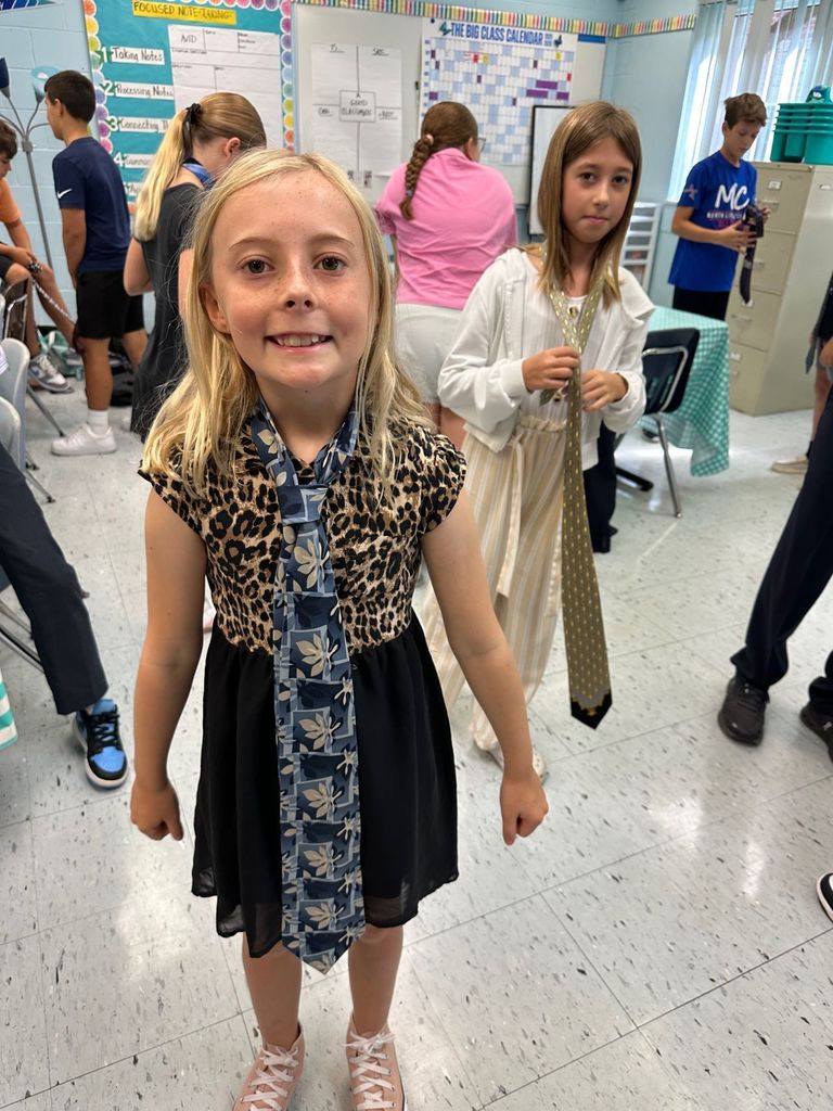 HOMS Principal teaches students how to tie a tie for AVID