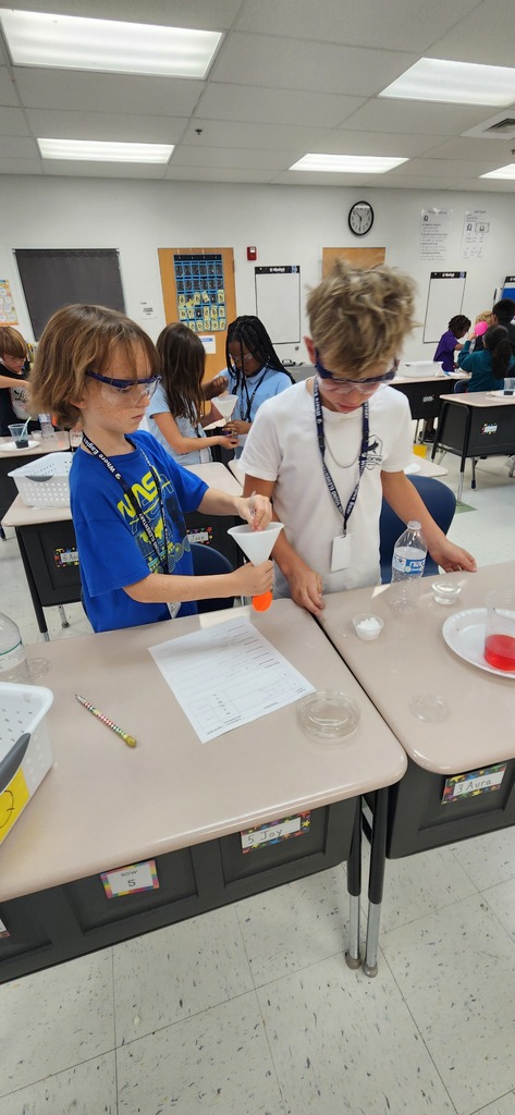 Hastings class completes an experiment using mystery powders and solunters to create chemical reactions