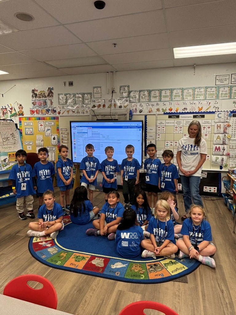 Kindergarten classes sitting nicely wearing their Character Counts T-shirts.