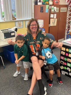 Two students and Ms Lucky in sports shirts